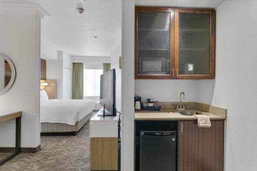 a hotel room with a kitchen and a bedroom at SpringHill Suites by Marriott Sacramento Natomas in Sacramento