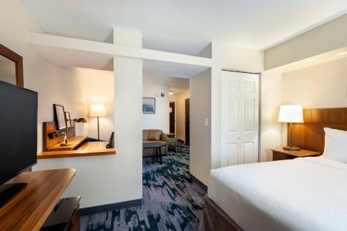 a hotel room with a bed and a television at Fairfield Inn & Suites Savannah Airport in Savannah