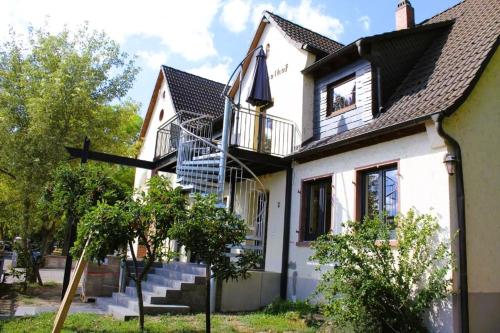 une maison blanche avec une croix devant elle dans l'établissement Dreimädelhof, à Rüdesheim am Rhein