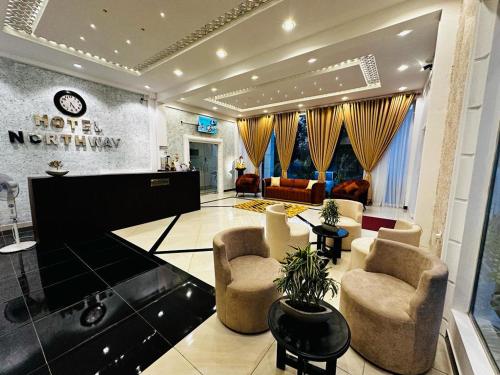 a living room with two chairs and a piano at Hotel NorthWay in Vavuniya