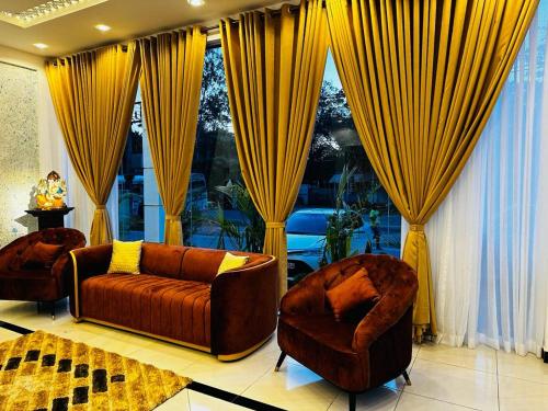 a living room with a couch and two chairs at Hotel NorthWay in Vavuniya