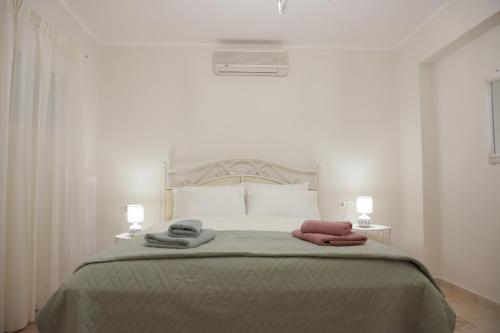 a bedroom with a bed with two towels on it at Perfect home for Relaxing in Artemida
