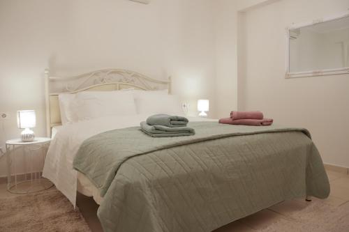 a bedroom with a bed with two towels on it at Perfect home for Relaxing in Artemida