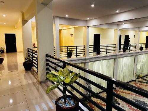 a lobby of a building with a potted plant at Hotel NorthWay in Vavuniya