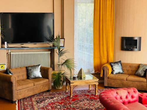 a living room with two couches and a flat screen tv at Villa Tanya in Trebbiantico