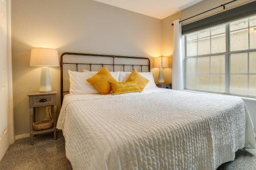 a bedroom with a bed with yellow pillows and a window at Branson Condo - 3 Mi to Table Rock State Park! in Branson