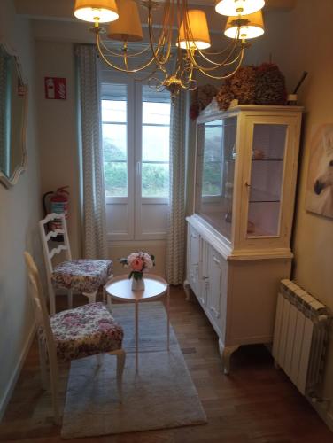 a room with a table and a cabinet and a window at VILLA OLIMAR 