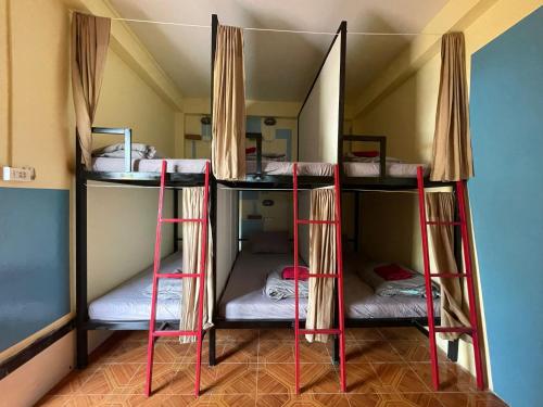 a group of bunk beds in a room at Over the Moon hostel in Ban Houayxay
