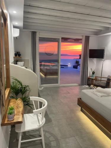 a bedroom with a bed and a view of the ocean at Eye of Naxos in Naxos Chora