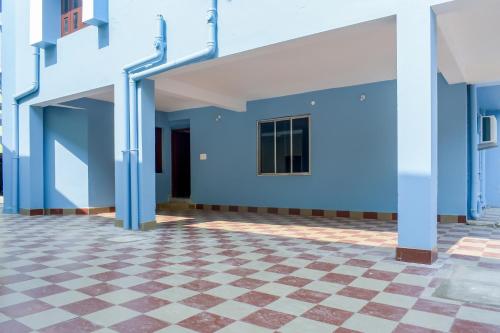 a building with blue walls and a checkered floor at OYO Home Elite Stay Near Shri Shri Shiridi Sai Mandir in Khandagiri