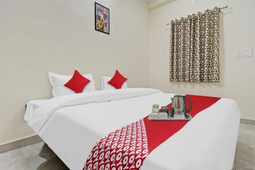 a bedroom with two beds with red and white sheets at OYO Flagship Hotel Green Apple in Jaipur