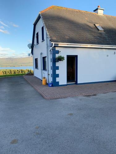 a white building with a black roof at Moriarty’s in Kenmare