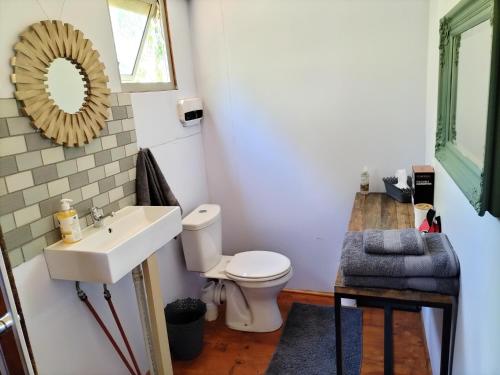 a bathroom with a sink and a toilet at Glamping at The Well in Franschhoek in Franschhoek