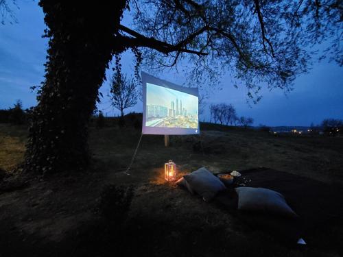 a large screen with a tent under a tree at Holiday home Vinovilla in Kutjevo