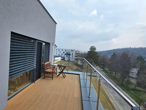 a balcony with a chair and a table on it at Penthouse apartmán Minerál B-4 in Bardejovské Kúpele