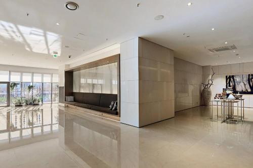 a large room with a couch and a table at Courtyard by Marriott Seoul Botanic Park in Seoul