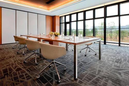 a large conference room with a long table and chairs at Courtyard by Marriott Seoul Botanic Park in Seoul