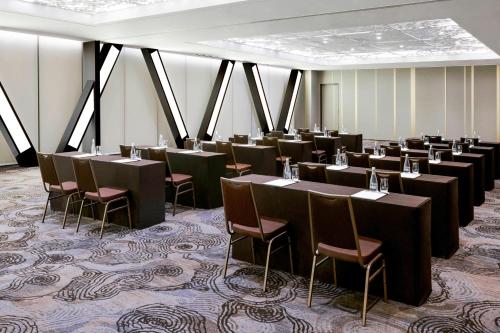 a row of tables and chairs in a room at Courtyard by Marriott Seoul Botanic Park in Seoul
