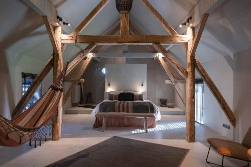 een slaapkamer met een bed en een hangmat in een kamer bij Chambres de Gilberoux in Floreffe