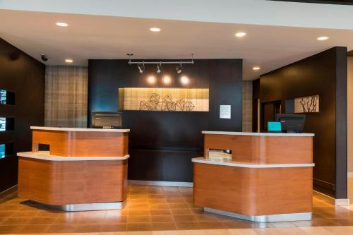 a hotel lobby with wooden counter tops in a room at Courtyard by Marriott Louisville Downtown in Louisville