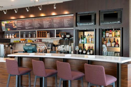 a bar with purple chairs in a restaurant at Courtyard by Marriott Louisville Downtown in Louisville