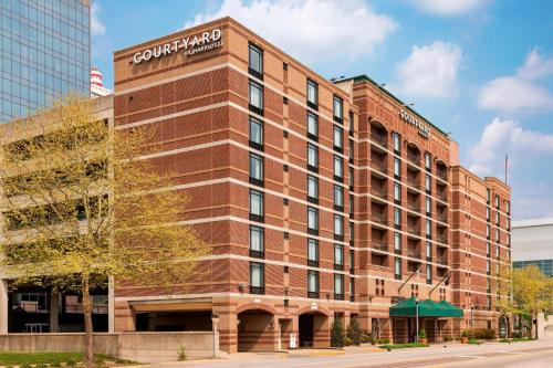 a red brick building with a sign on it at Courtyard Louisville Downtown in Louisville
