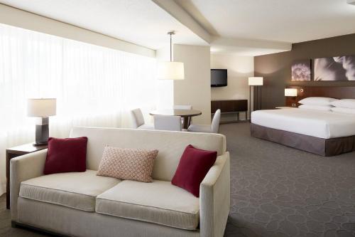 a hotel room with a couch and a bed at Delta Hotels by Marriott Quebec in Quebec City