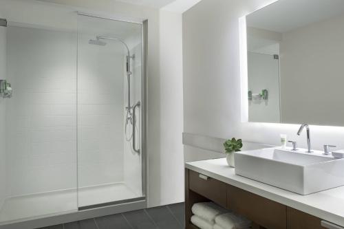 a white bathroom with a sink and a shower at Element Vaughan Southwest in Vaughan