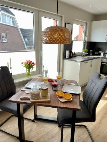 a table with food on it in a kitchen at Ferienwohnung Dünenbutze in Büsum