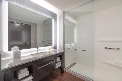 a bathroom with a sink and a mirror at Residence Inn by Marriott Manchester Downtown in Manchester
