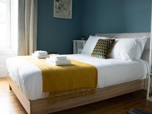ein Schlafzimmer mit einem Bett mit einer gelben Decke darauf in der Unterkunft Garnethill Upper in Glasgow