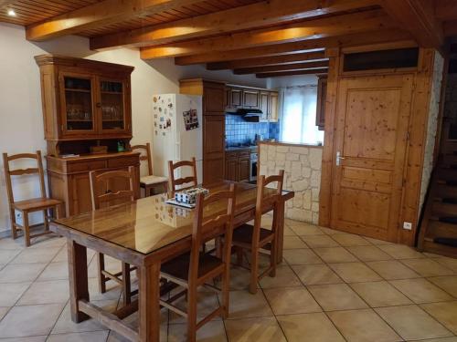 een keuken met een houten tafel en een koelkast bij Maison individuelle 5 personnes in Villar-Saint-Pancrace