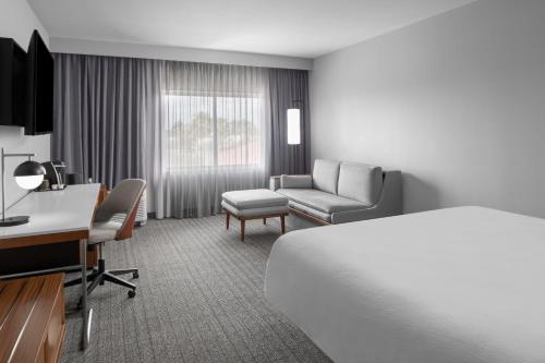 a hotel room with a bed and a desk at Courtyard Tampa Oldsmar in Oldsmar