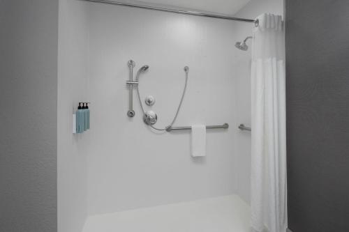 a bathroom with a shower with a cross on the wall at Courtyard Tampa Oldsmar in Oldsmar