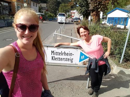 two girls are standing next to a street sign at RheinWeinBoppard 2 - mit Rheinblick in Boppard