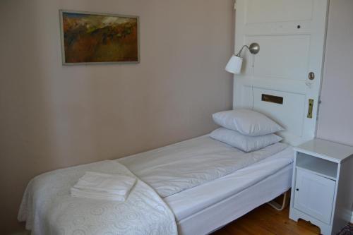 a bed with two pillows on it in a room at Lilla Hotellet Bed & Breakfast i Alingsås in Alingsås