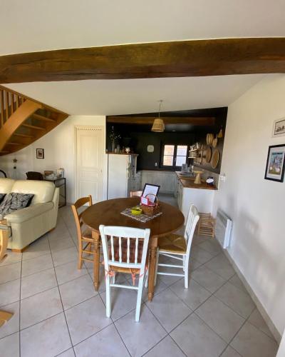une cuisine et un salon avec une table et des chaises dans l'établissement La Grange du marais de Sailly-Bray, à Noyelles-sur-Mer