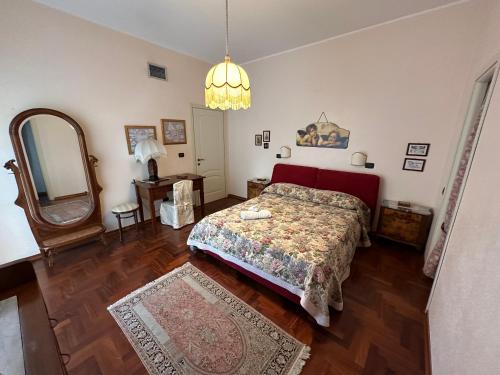 a bedroom with a bed and a mirror at Mamma Mary Apartment in Siracusa