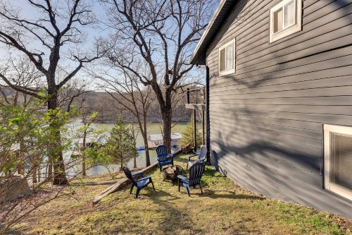 a group of chairs sitting on the side of a house at Deck, Fire Pit and Grill Lakefront Oklahoma Abode in Jay