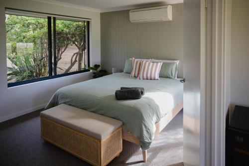 a bedroom with a large bed and a window at Djilba Cottage at Windance in Yallingup