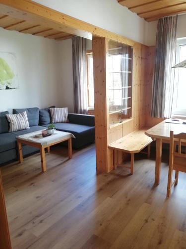 a living room with a blue couch and a table at Alte Innbrücke in Schärding