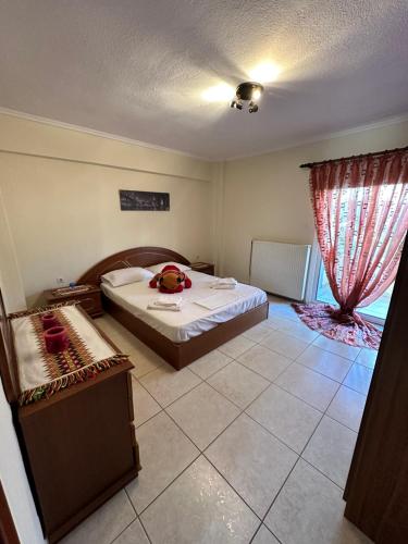 a bedroom with a large bed and a window at Archontia Apartment in Flogita