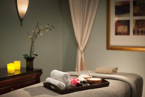 a hotel room with a tray of towels and a bed at Marriott Savannah Riverfront in Savannah