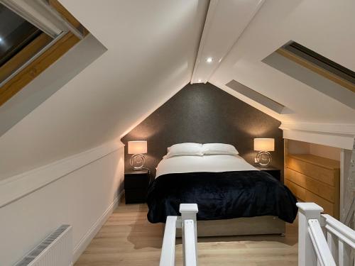 a bedroom with a bed in a attic at The Penthouse at Ty Gwyn in Llandudno