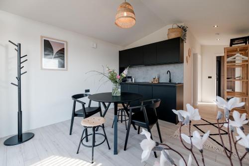 a kitchen and dining room with a table and chairs at B-LESS in Blankenberge