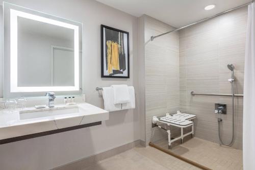 a bathroom with a sink and a shower at Delta Hotels by Marriott Vancouver Downtown Suites in Vancouver