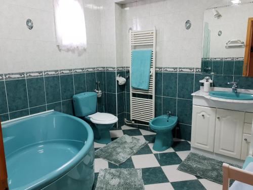 a bathroom with a tub and a toilet and a sink at Antal Apartmans Lunca de Sus Kulcsosház Gyimesfelsőlok in Lunca de Sus