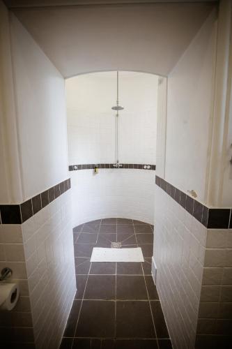 a bathroom with a shower with a tiled floor at Château Rhianfa in Menai Bridge