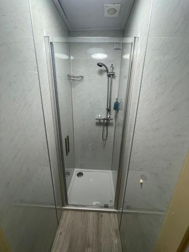 a shower with a glass door in a bathroom at The George Hotel in Whitby