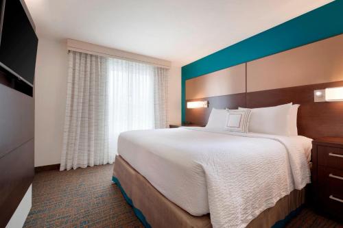 a hotel room with a large bed and a window at Residence Inn San Angelo in San Angelo